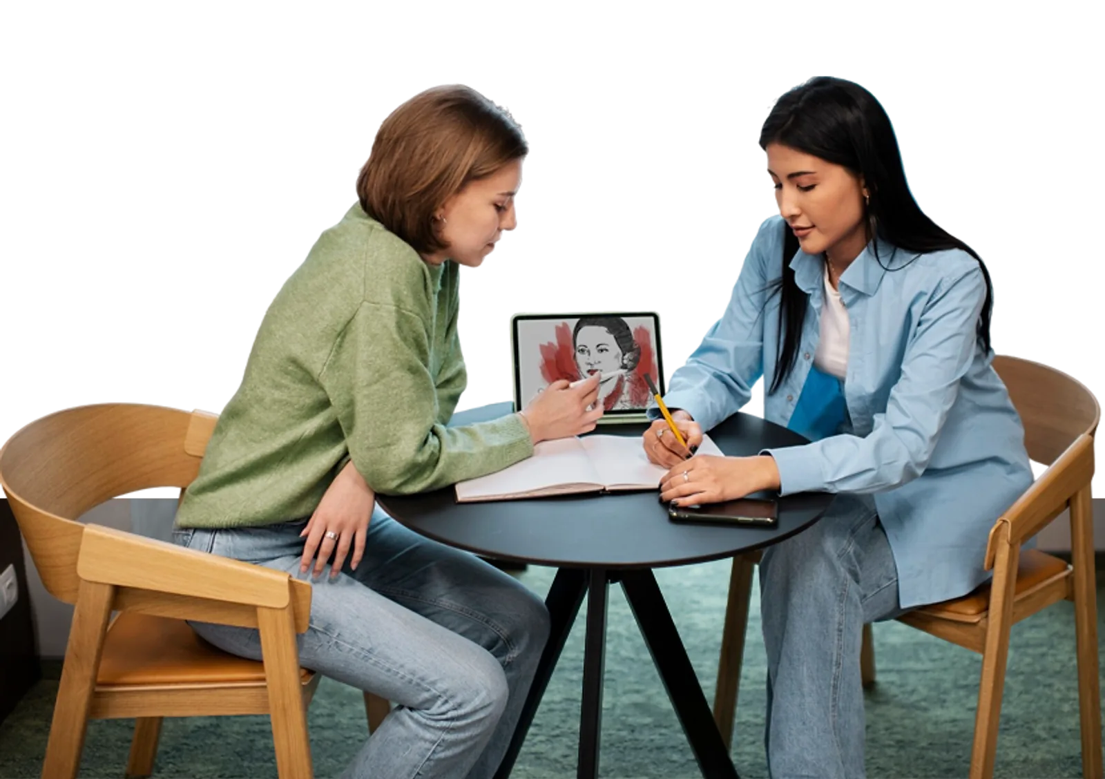 Two women discuss artwork on a tablet during an LLND support session.