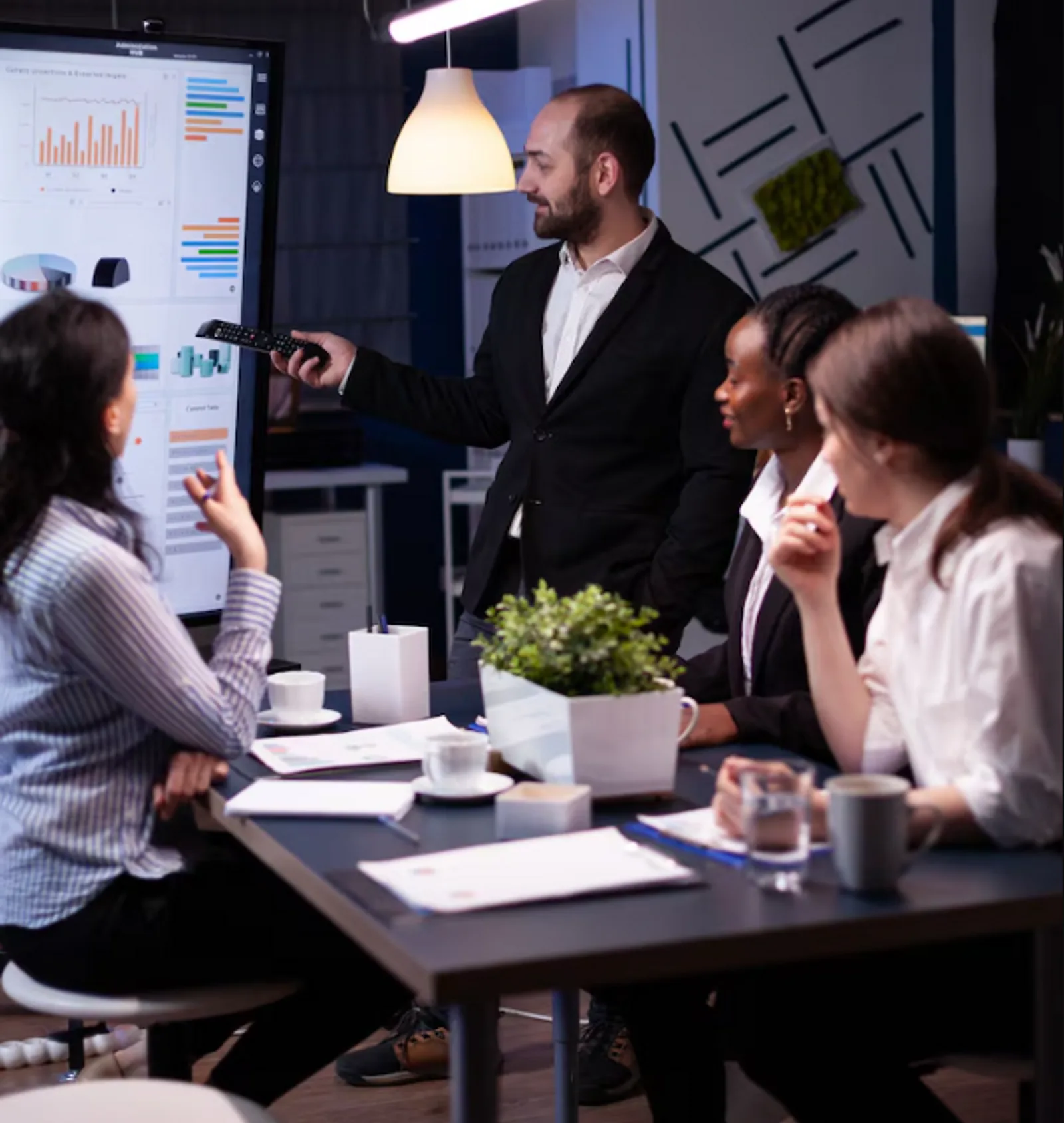 A man presents data analysis to colleagues during an LLND program meeting, demonstrating employability skills.