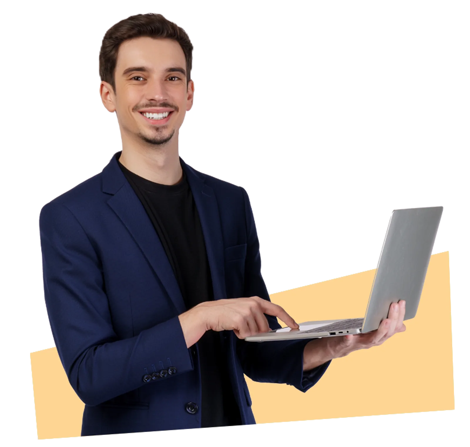 A smiling man in a suit types on a laptop during LLND training.