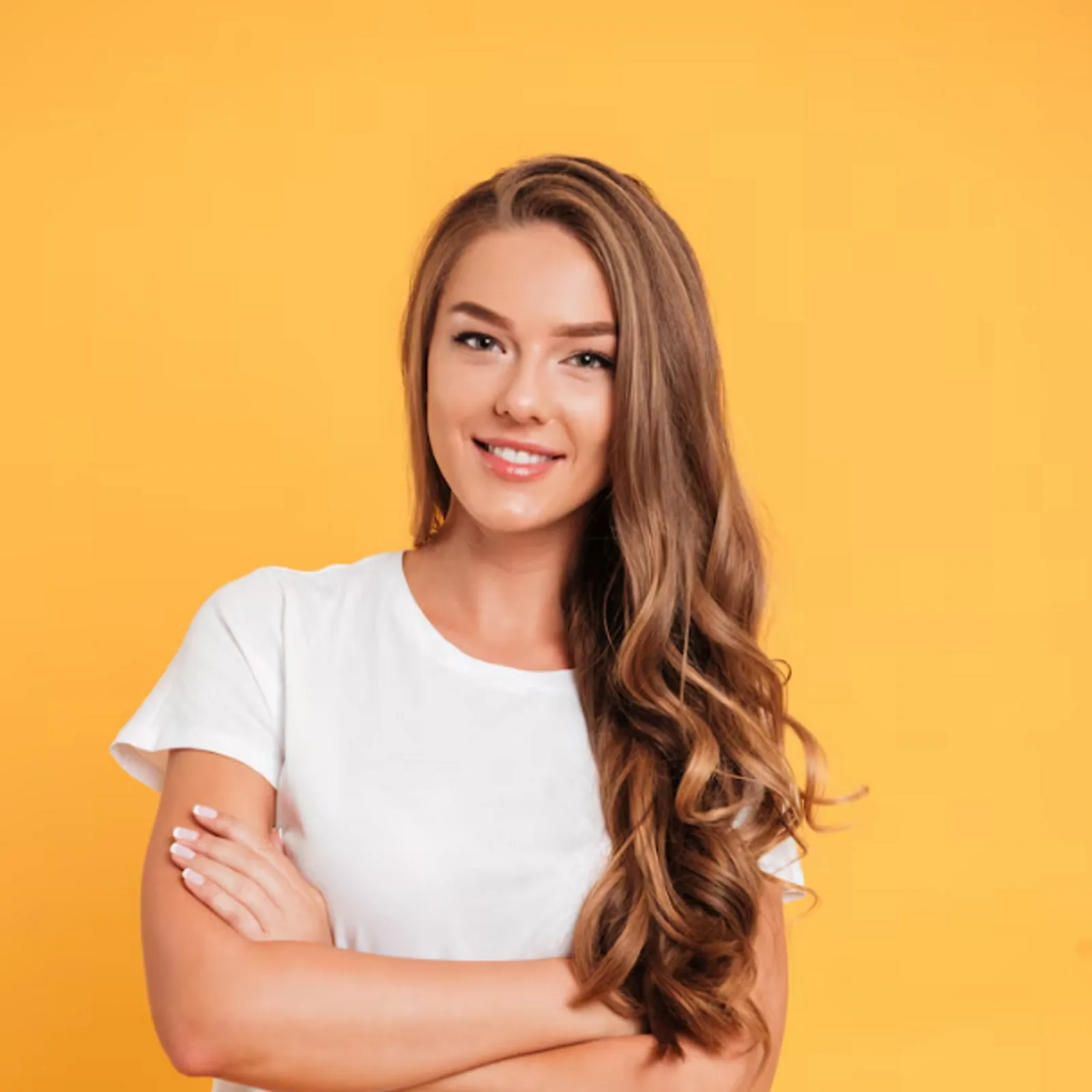 A smiling woman with long wavy hair poses, representing CAQA LLND's approach to foundational skills training.