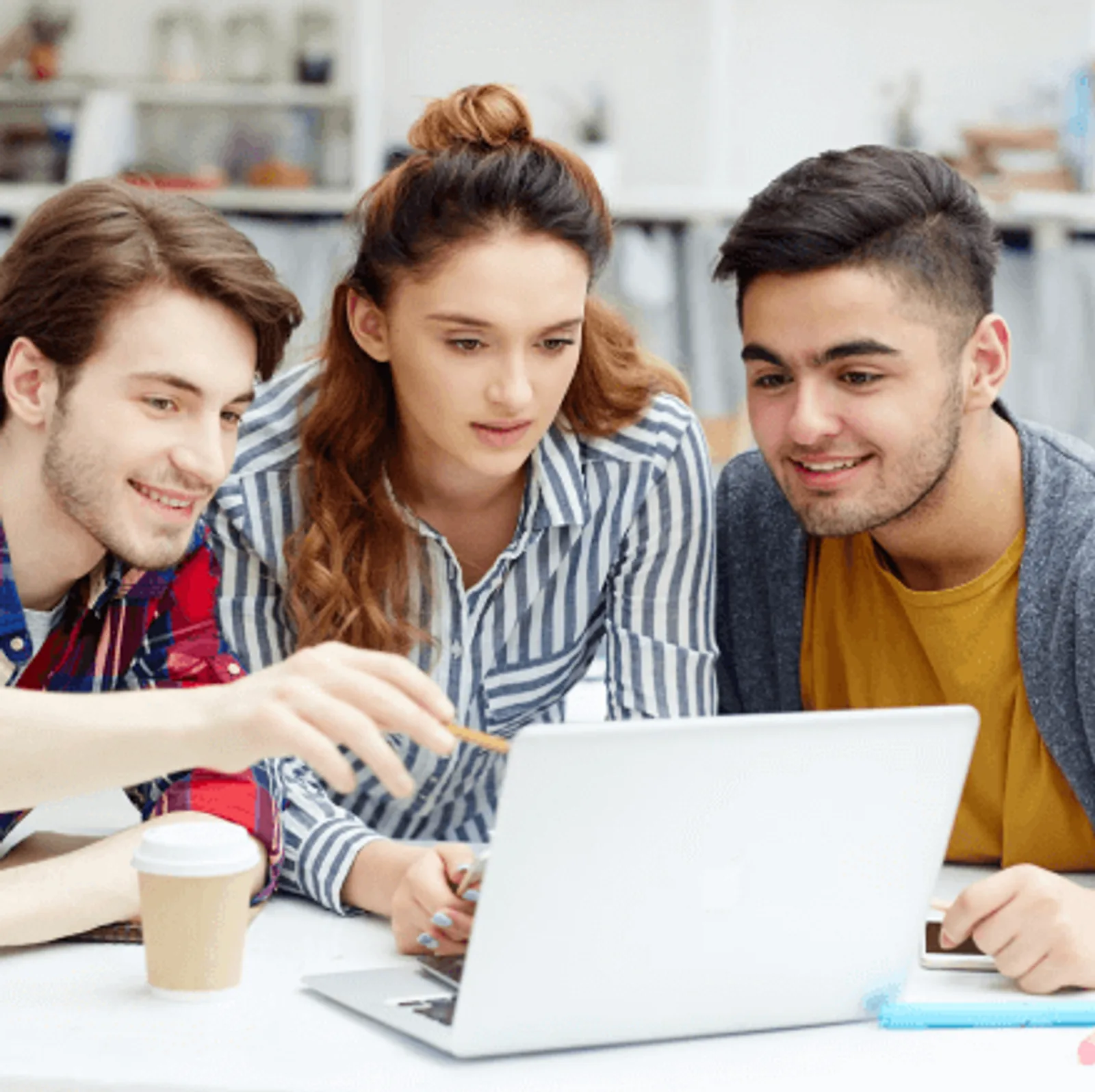 Three students collaborate on a laptop during an LLND assessment training session.
