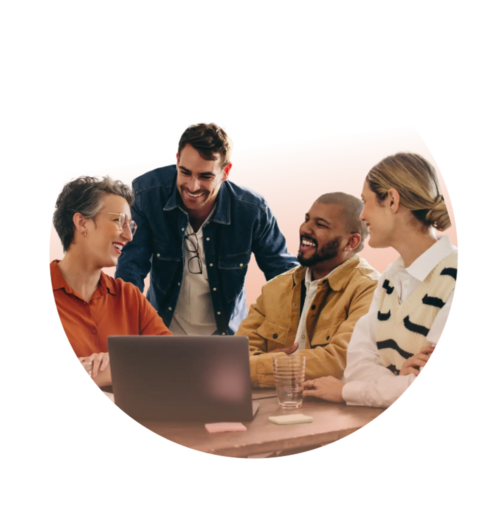 Four colleagues collaborate around a laptop during a cheerful meeting, demonstrating effective teamwork for foundation.