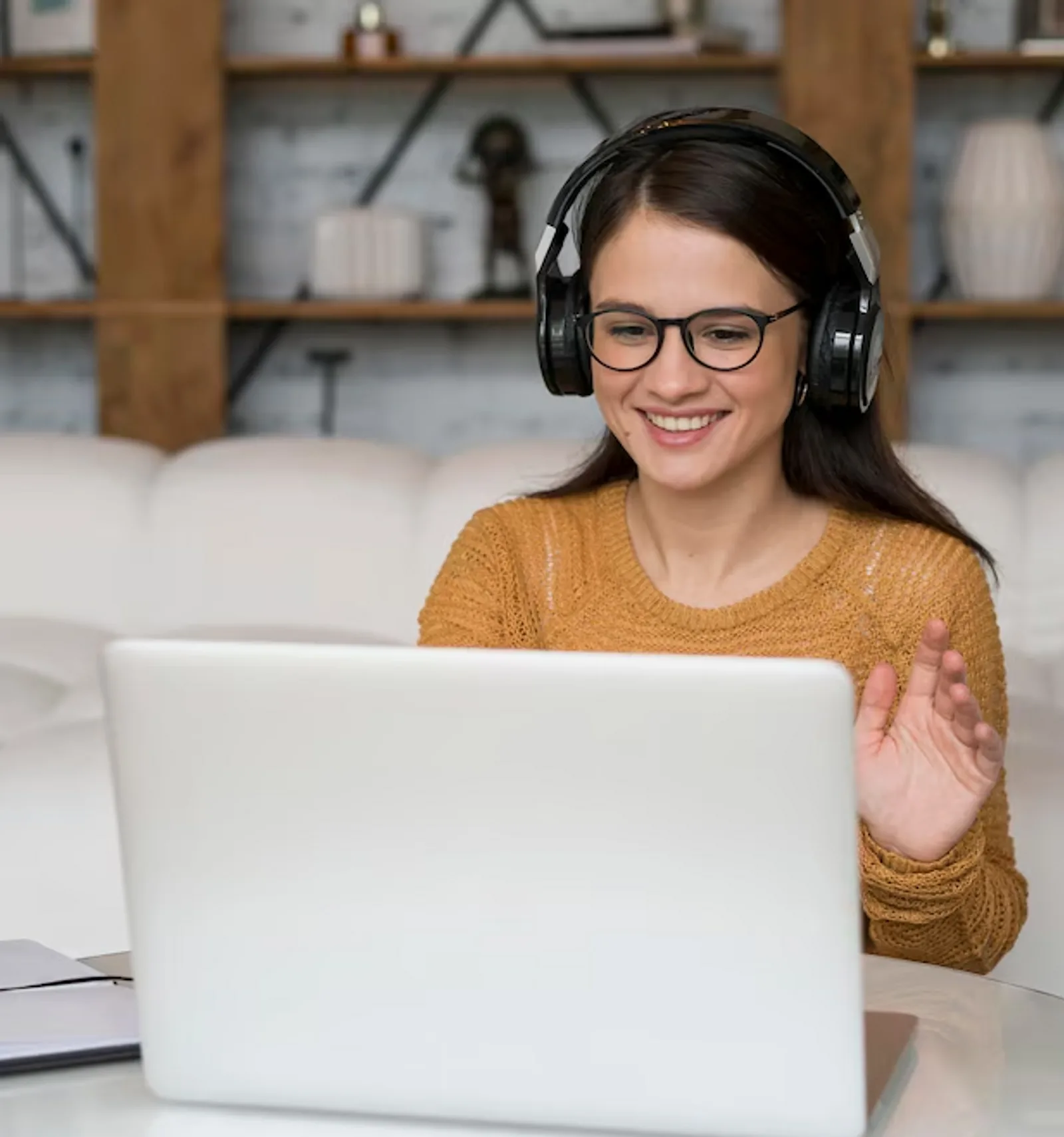 A woman participates in a video conference on her laptop, demonstrating blended learning for foundational skills.