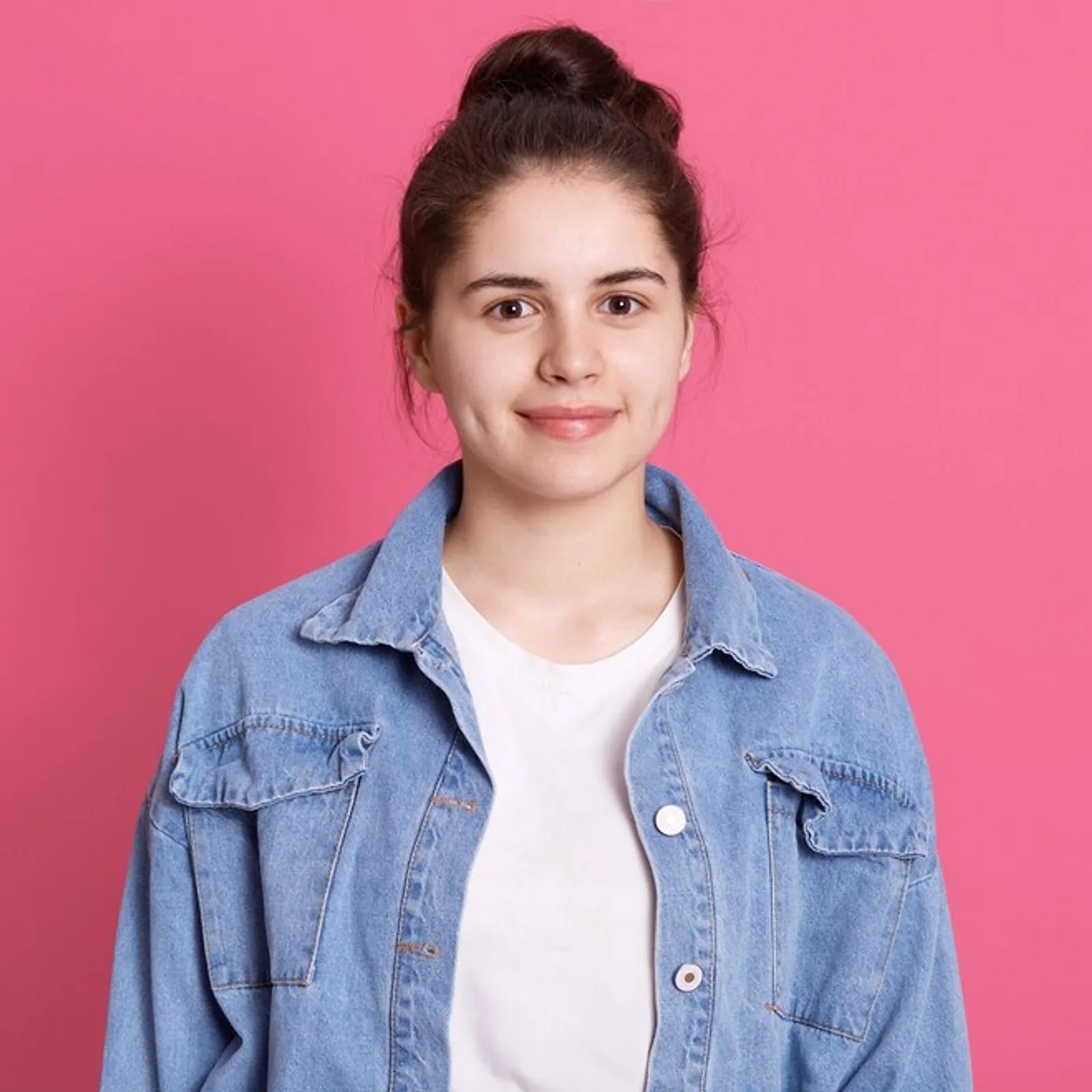 A young woman with brown hair wearing a denim jacket, representing foundational skills training.